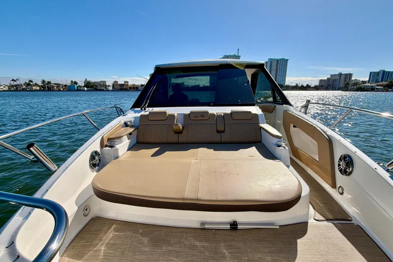 Slide: The Image of 2022 Sea Ray Sundancer 320 boat interior with sunpad, on a sunny day by the water. - 19