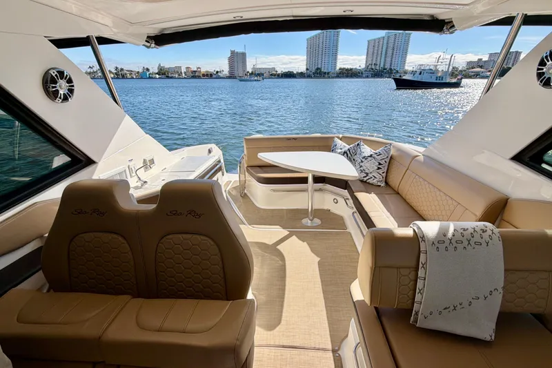 Slide: The Image of Luxurious 2022 Sea Ray Sundancer 320 interior with waterfront view and elegant seating. - 27