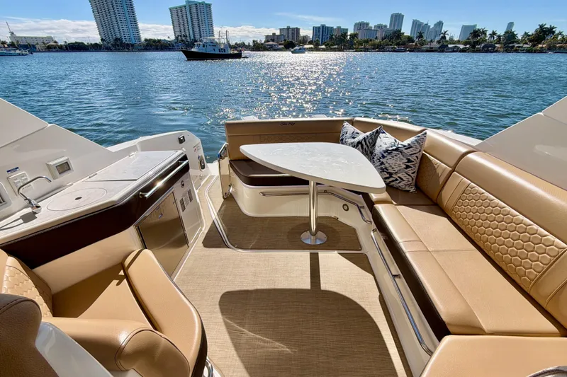 Slide: The Image of Luxurious 2022 Sea Ray Sundancer 320 yacht interior with elegant seating and scenic waterfront view. - 29