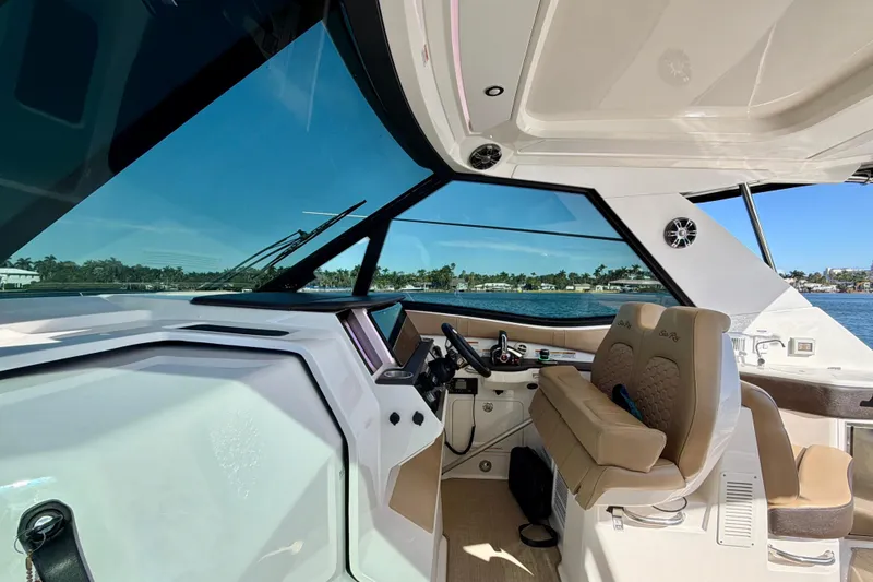 Slide: The Image of 2022 Sea Ray Sundancer 320 helm with luxurious seating and panoramic water views. - 3