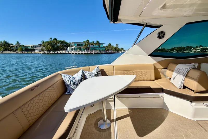 Slide: The Image of Luxurious 2022 Sea Ray Sundancer 320 yacht interior with elegant seating and scenic waterfront view. - 31