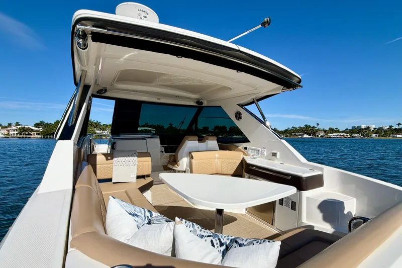 Slide: The Image of 2022 Sea Ray Sundancer 320 yacht interior with luxurious seating and table on a sunny day. - 35