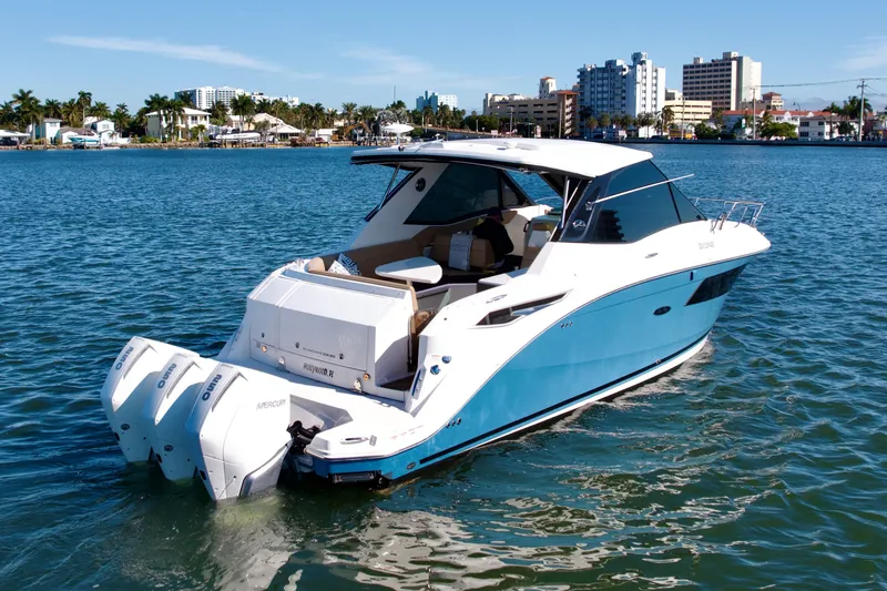 Slide: The Image of 2022 Sea Ray Sundancer 320 boat on water, cityscape in background. - 37