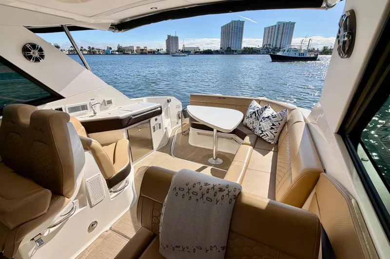 Slide: The Image of Luxurious 2022 Sea Ray Sundancer 320 yacht interior with plush seating and scenic waterfront view. - 4