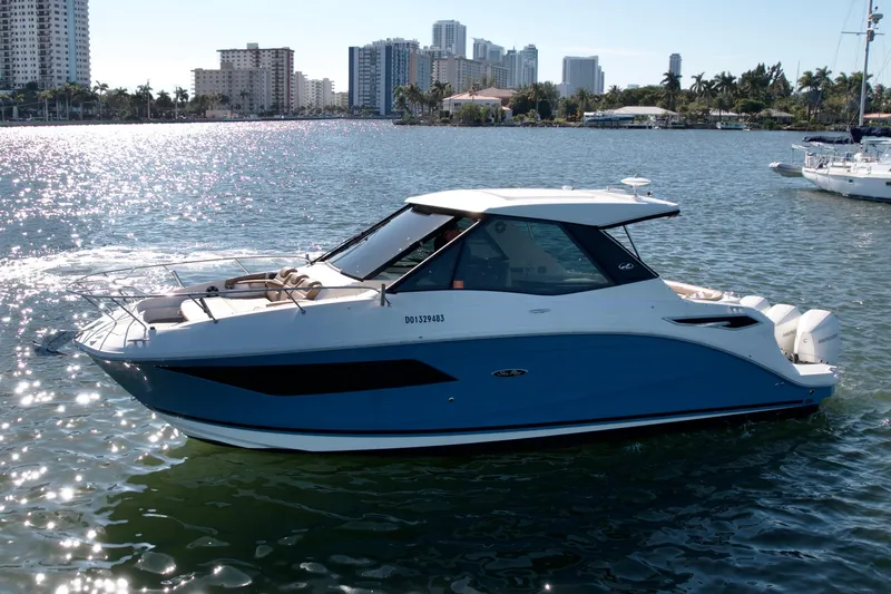 Slide: The Image of 2022 Sea Ray Sundancer 320 boat on water with city skyline background. - 41