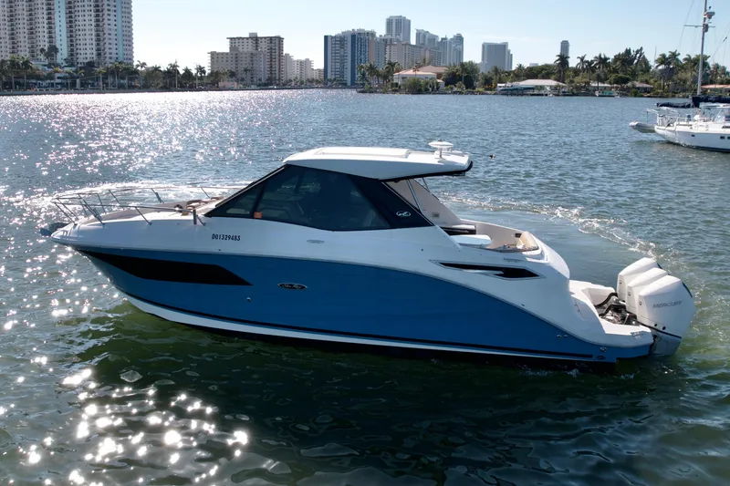 Slide: The Image of 2022 Sea Ray Sundancer 320 cruising on a sunny day near city skyline. - 42