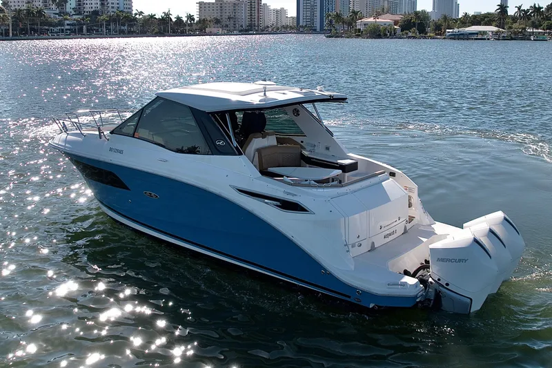 Slide: The Image of 2022 Sea Ray Sundancer 320 cruising on a sunny day, showcasing sleek design and powerful engines. - 43