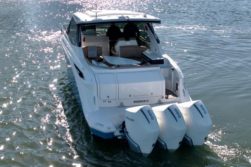 Slide: The Image of 2022 Sea Ray Sundancer 320 cruising on sparkling water with triple Mercury outboards. - 44