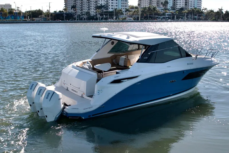 Slide: The Image of 2022 Sea Ray Sundancer 320 boat on water, cityscape background, sunny day. - 45