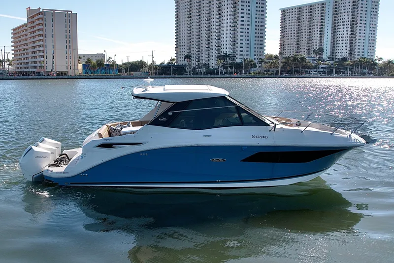 Slide: The Image of 2022 Sea Ray Sundancer 320 yacht on water, city skyline in background. - 46