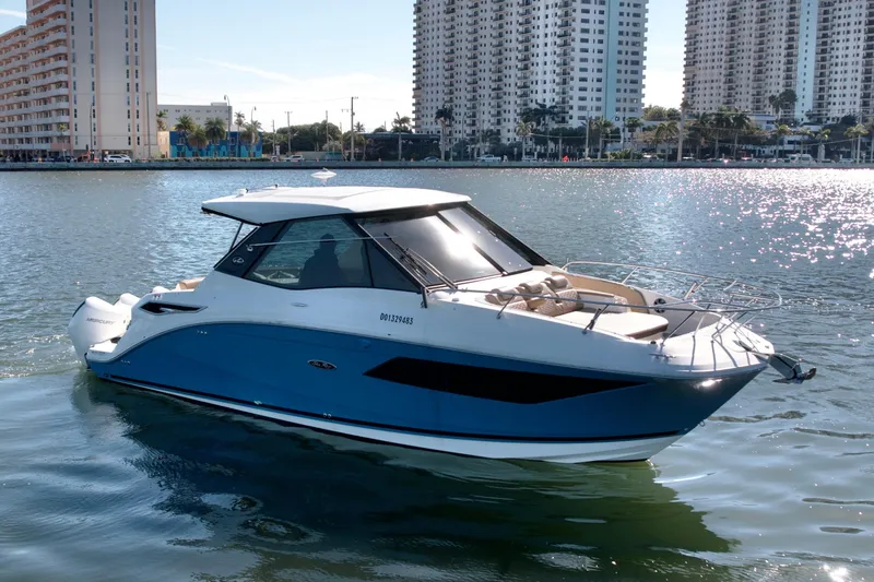 Slide: The Image of 2022 Sea Ray Sundancer 320 yacht cruising in sunny waterfront cityscape. - 48