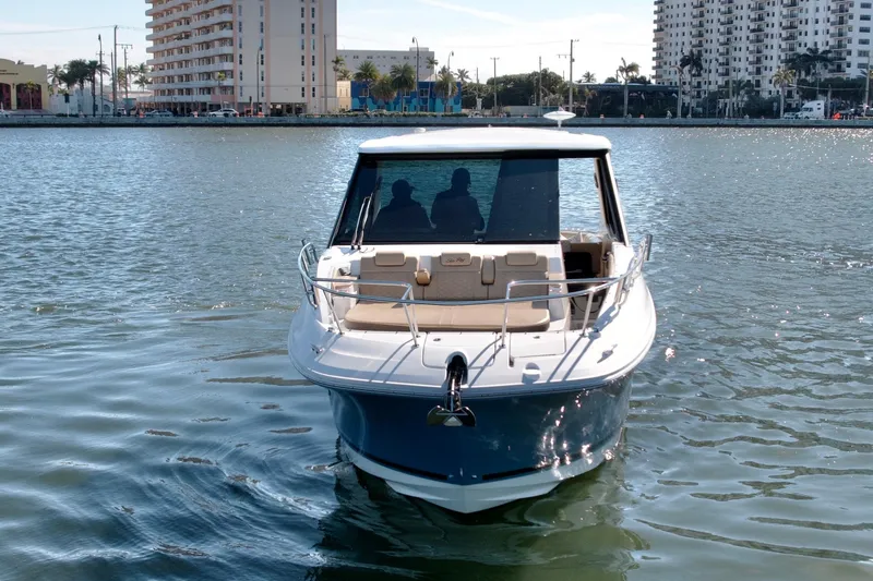 Slide: The Image of 2022 Sea Ray Sundancer 320 yacht cruising in urban waterfront setting. - 50