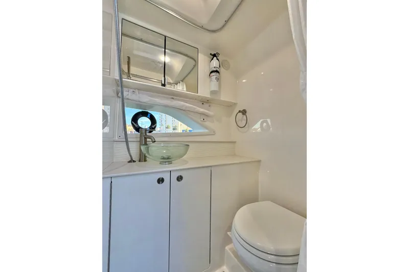 Slide: The Image of 2022 Sea Ray Sundancer 320 bathroom with modern sink, mirror, and toilet. - 6