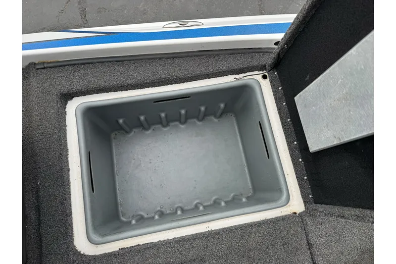 Slide: The Image of Livewell compartment in 2022 Nitro Z20 Pro boat, featuring gray interior and carpeted edges. - 15