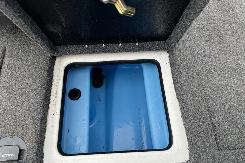 Slide: The Image of Open storage compartment in 2022 Nitro Z20 Pro boat, featuring a blue interior. - 16