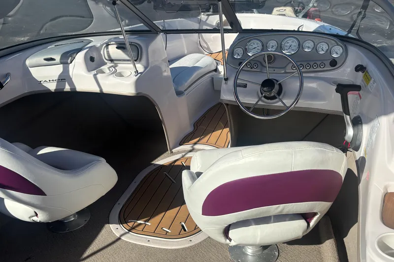 Slide: The Image of Interior of a 2008 Tahoe Q6 SF boat with steering wheel and dashboard controls. - 11