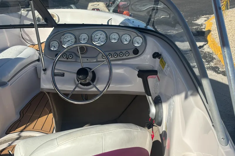 Slide: The Image of Steering console of a 2008 Tahoe Q6 SF boat with gauges and controls. - 12