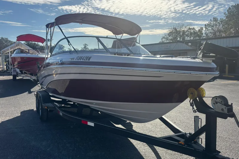 Slide: The Image of 2008 Tahoe Q6 SF boat on trailer under sunny sky. - 2