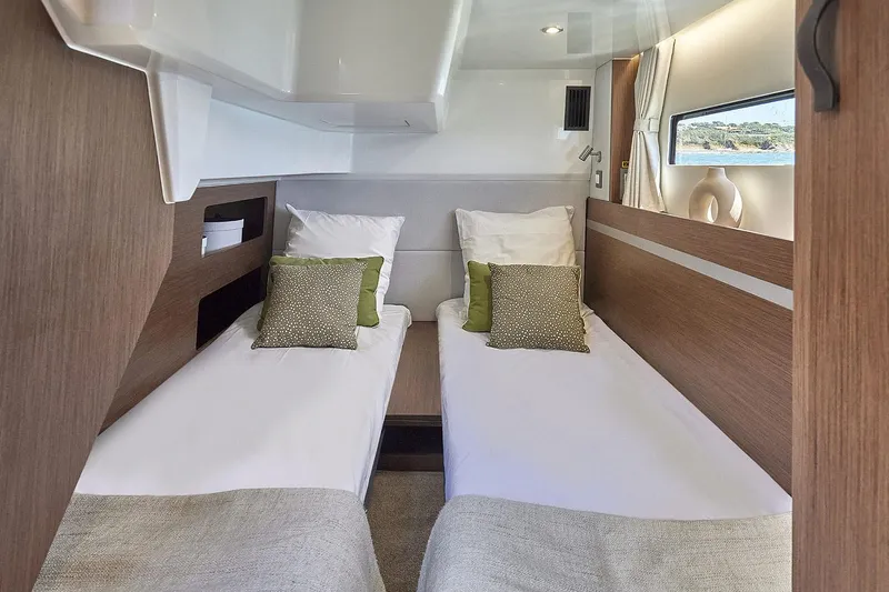 Slide: The Image of Manufacturer Provided Image: Interior cabin of 2025 Beneteau Antares 12 Fly with twin beds and modern decor. - 10