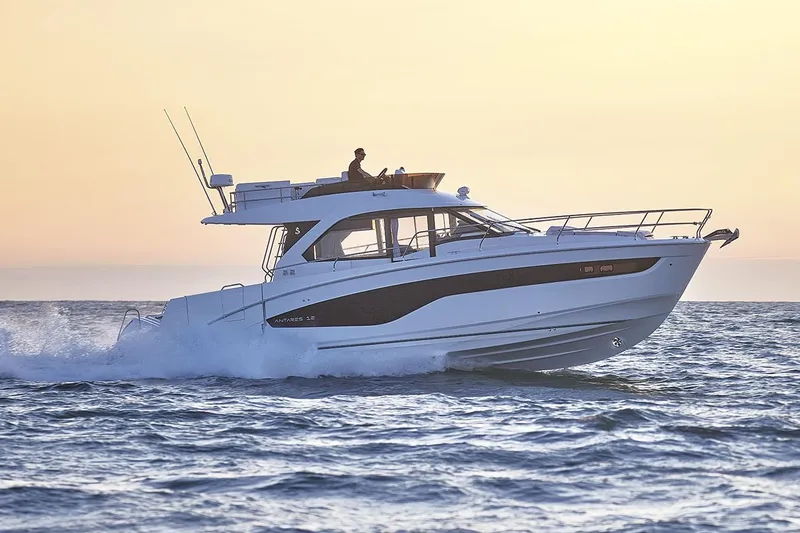 Slide: The Image of Manufacturer Provided Image: 2025 Beneteau Antares 12 Fly cruising on open water at sunset. - 3