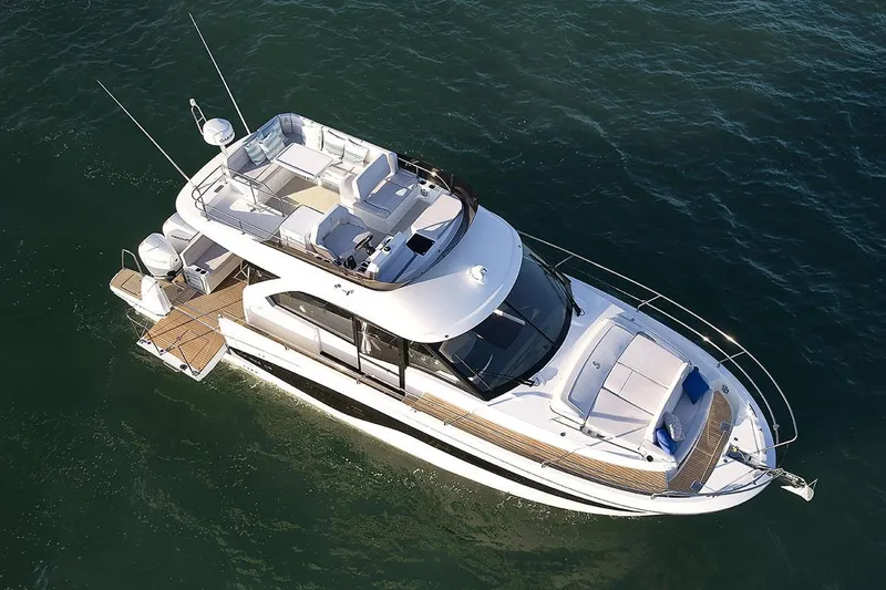 Slide: The Image of Manufacturer Provided Image: 2025 Beneteau Antares 12 Fly yacht cruising on open water, aerial view. - 4