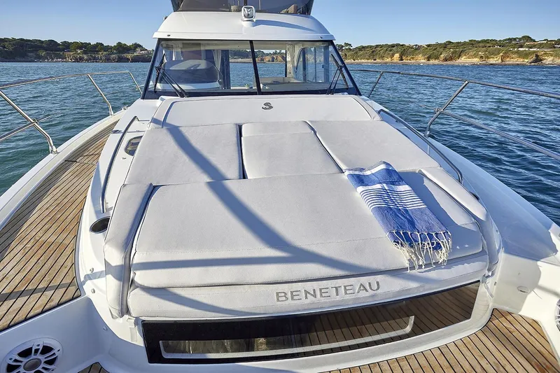 Slide: The Image of Manufacturer Provided Image: 2025 Beneteau Antares 12 Fly yacht with sunbed and towel on deck. - 5