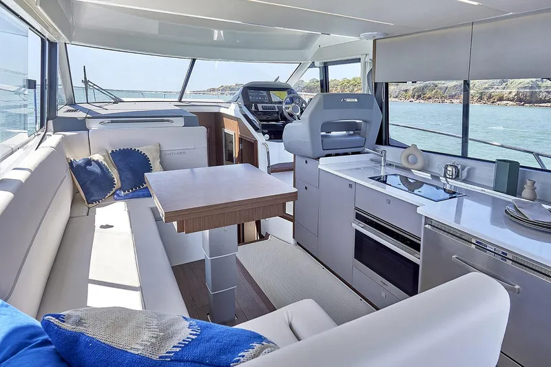 Slide: The Image of Manufacturer Provided Image: Luxurious interior of 2025 Beneteau Antares 12 Fly yacht with modern kitchen and seating area. - 8