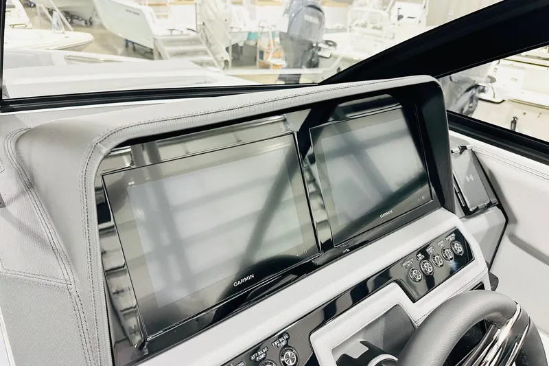 Slide: The Image of 2026 Cobalt R6 Outboard dashboard with dual Garmin displays and modern controls. - 3