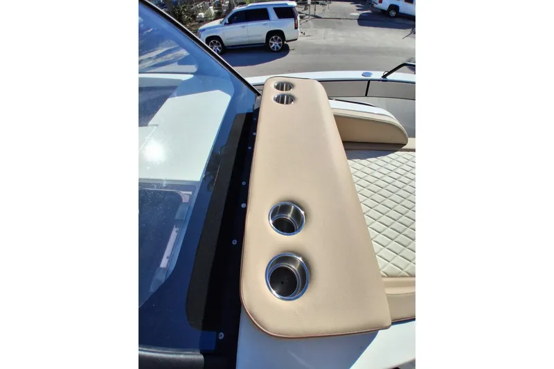 Slide: The Image of 2027 Zodiac X10CC boat interior with beige upholstery and cup holders. - 13