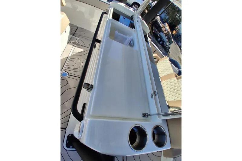 Slide: The Image of 2027 Zodiac X10CC boat interior with cup holders and cushioned seating. - 15