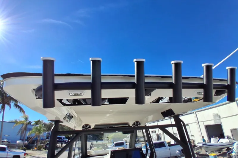 Slide: The Image of 2027 Zodiac X10CC boat with rod holders under clear blue sky. - 5