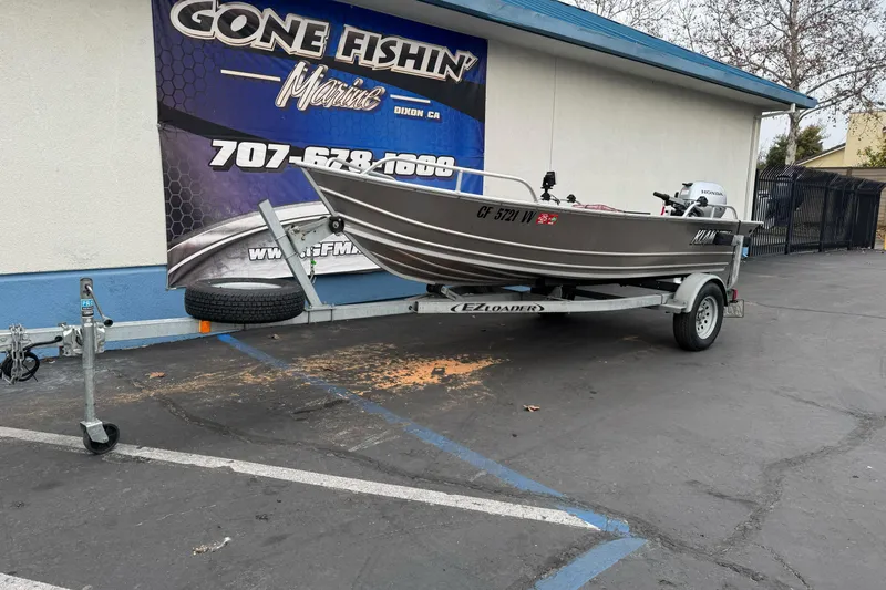 Slide: The Image of 2023 Klamath 14 Deluxe boat on trailer at Gone Fishin' Marine dealership. - 1