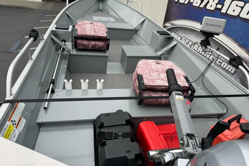 Slide: The Image of 2023 Klamath 14 Deluxe boat interior with Garmin equipment and pink seats. - 6