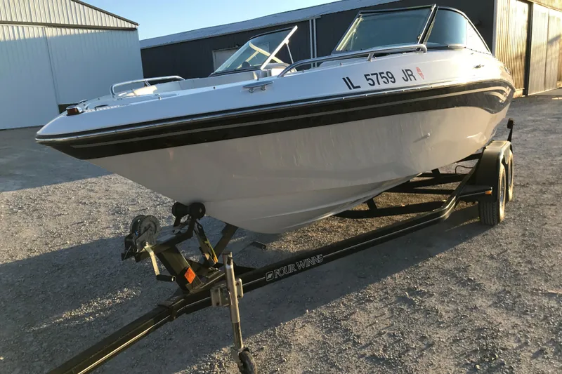 Slide: The Image of 2001 Four Winns 200 Horizon boat on trailer, parked outdoors. - 10