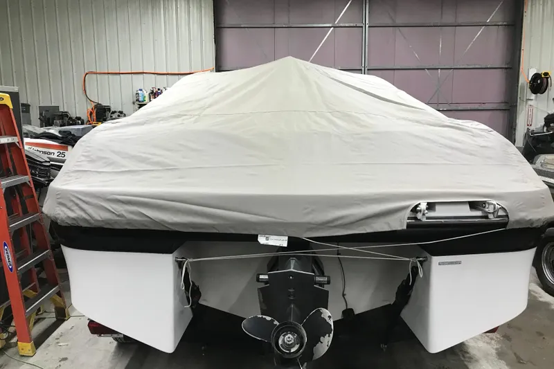 Slide: The Image of 2001 Four Winns 200 Horizon boat covered in storage, rear view in a garage. - 27