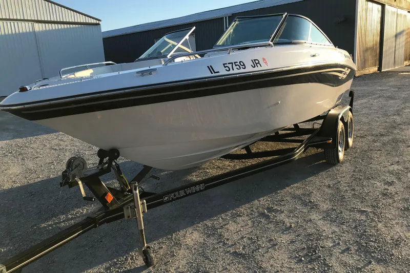 Slide: The Image of 2001 Four Winns 200 Horizon boat on trailer, parked outdoors in sunlight. - 3