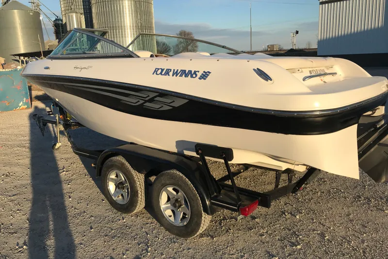Slide: The Image of 2001 Four Winns 200 Horizon boat on trailer, parked outdoors. - 4