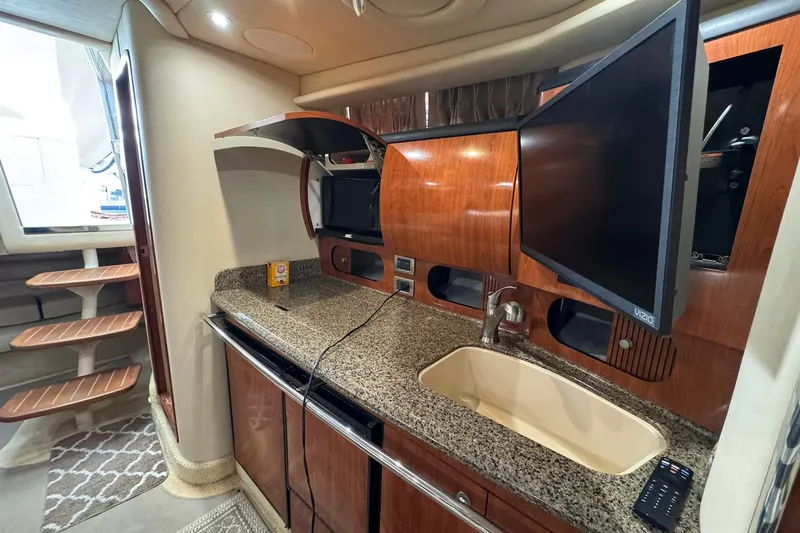 Slide: The Image of Interior of 2005 Sea Ray 360 Sundancer yacht with kitchenette and TV. - 11