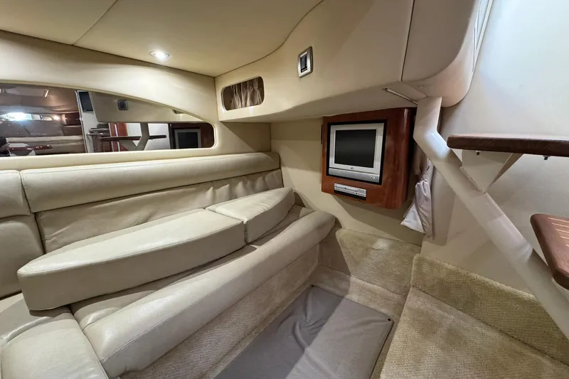 Slide: The Image of Interior of 2005 Sea Ray 360 Sundancer with beige seating and built-in TV. - 20