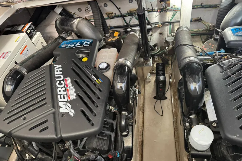 Slide: The Image of Engine compartment of a 2005 Sea Ray 360 Sundancer with Mercury engines. - 24