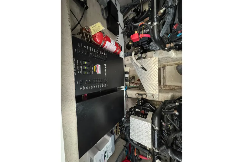 Slide: The Image of Engine compartment of a 2005 Sea Ray 360 Sundancer with control panel and fire extinguisher. - 25