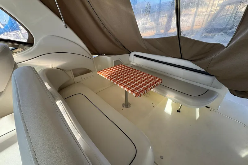 Slide: The Image of Interior of 2005 Sea Ray 360 Sundancer with checkered table and cushioned seating. - 6