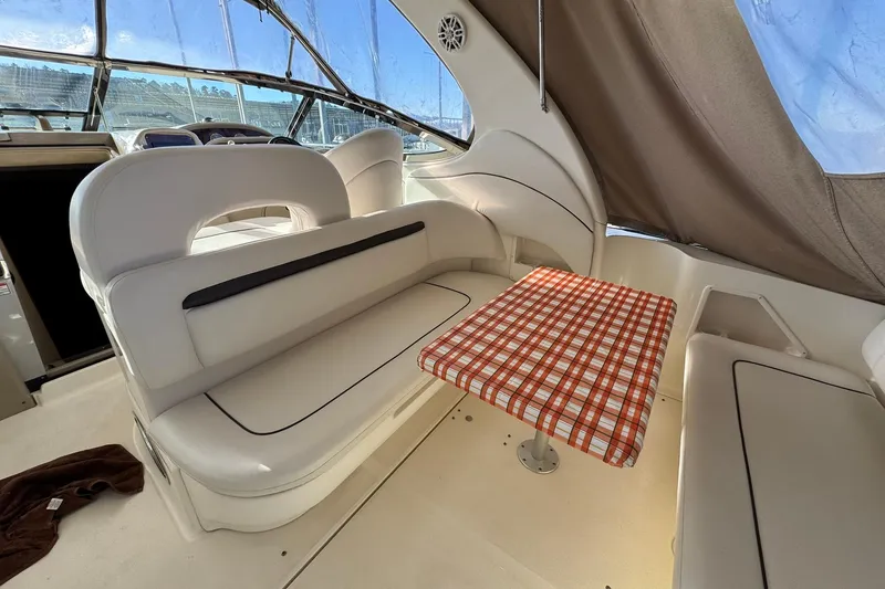 Slide: The Image of Interior of 2005 Sea Ray 360 Sundancer with seating and plaid table. - 7