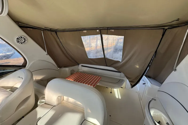 Slide: The Image of Interior of a 2005 Sea Ray 360 Sundancer with seating and a small table. - 9
