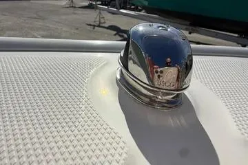 Slide: The Image of 2018 Boston Whaler 170 Super Sport boat detail with chrome fixture on textured surface. - 10