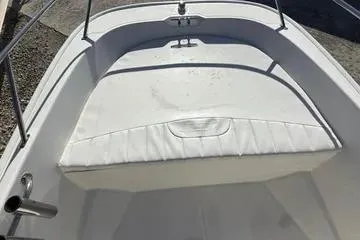 Slide: The Image of 2018 Boston Whaler 170 Super Sport boat interior with white seating and stainless steel railings. - 11