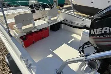 Slide: The Image of 2018 Boston Whaler 170 Super Sport boat interior with seating and Mercury engine. - 19
