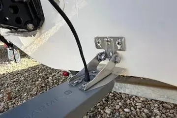 Slide: The Image of 2018 Boston Whaler 170 Super Sport boat transom with mounted equipment on gravel. - 25