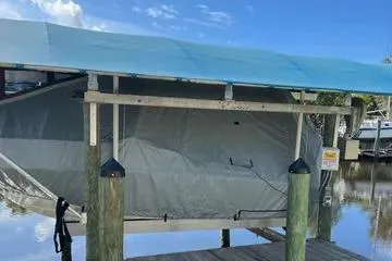 Slide: The Image of 2018 Boston Whaler 170 Super Sport covered at a dock with blue canopy. - 5