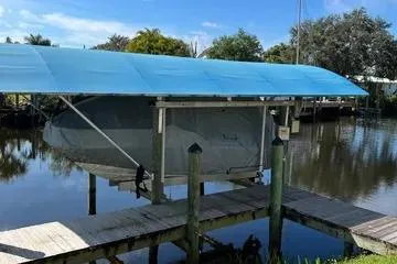 Slide: The Image of 2018 Boston Whaler 170 Super Sport on a covered dock by a calm river. - 7